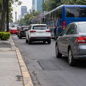 AI illustration of ordinary vehicles beside a worn Mexico City curb